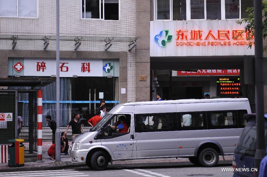 Employees of the Hsu Chi Food Co. Ltd are sent to a hospital in Dongguan, south China's Guangdong Province, June 11, 2013. A total of 160 staff from the food company were suspected of suffering from food poisoning, a company source said on Wednesday. (Xinhua/Wu Lu) 