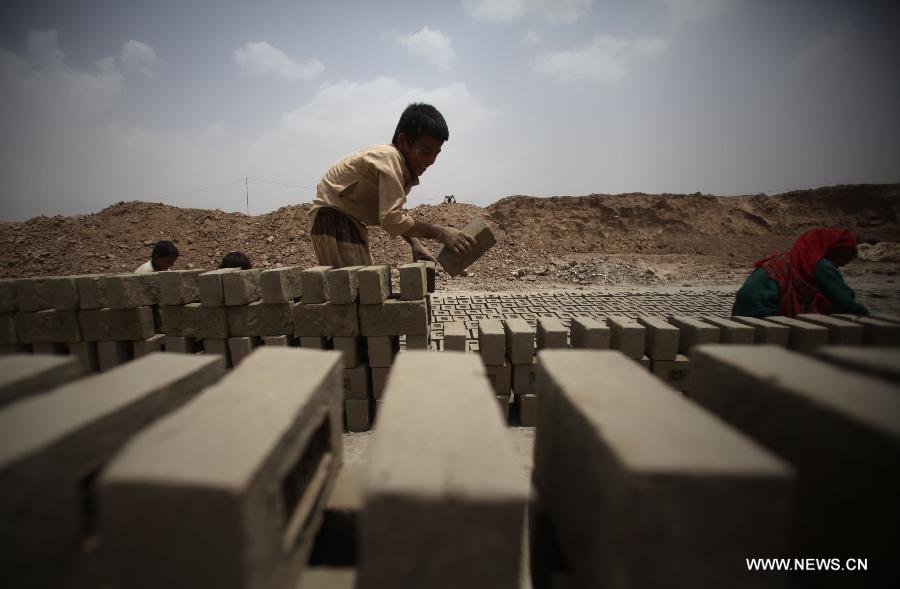 An Afghan child works at a brick factory in Kabul, Afghanistan on June 12, 2013. Afghan labor children work as usual on June 12 while many countries around the world mark the day as the World Day Against Child Labor. The International Labor Organization (ILO) launched the World Day Against Child Labor in 2002, which falls on each June 12. (Xinhua/Ahmad Massoud) 