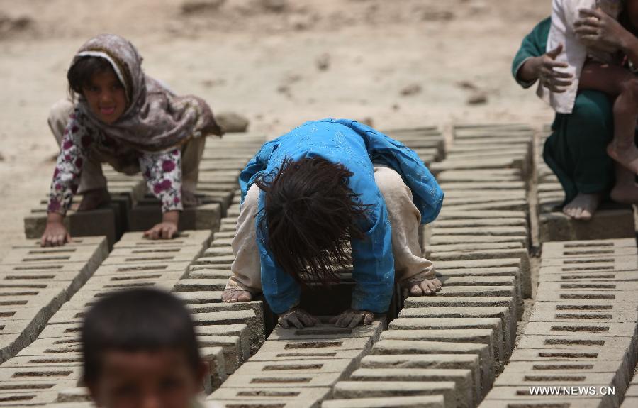 Afghan children work at a brick factory in Kabul, Afghanistan on June 12, 2013. Afghan labor children work as usual on June 12 while many countries around the world mark the day as the World Day Against Child Labor. The International Labor Organization (ILO) launched the World Day Against Child Labor in 2002, which falls on each June 12. (Xinhua/Ahmad Massoud) 