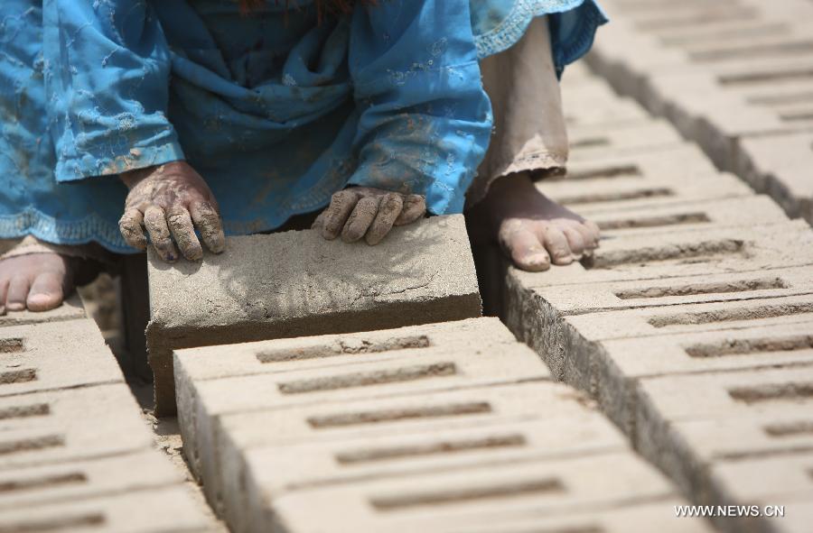 An Afghan child works at a brick factory in Kabul, Afghanistan on June 12, 2013. Afghan labor children work as usual on June 12 while many countries around the world mark the day as the World Day Against Child Labor. The International Labor Organization (ILO) launched the World Day Against Child Labor in 2002, which falls on each June 12. (Xinhua/Ahmad Massoud) 
