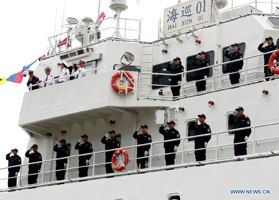 Crew members stand on the deck of the ship "Haixun 01" of China's Maritime Safety Administration (MSA) before leaving Shanghai, east China, June 10, 2013. The public service ship will conduct a 62-day voyage to visit Australia, Indonesia, Myanmar and Malaysia. (Xinhua/Chen Fei)