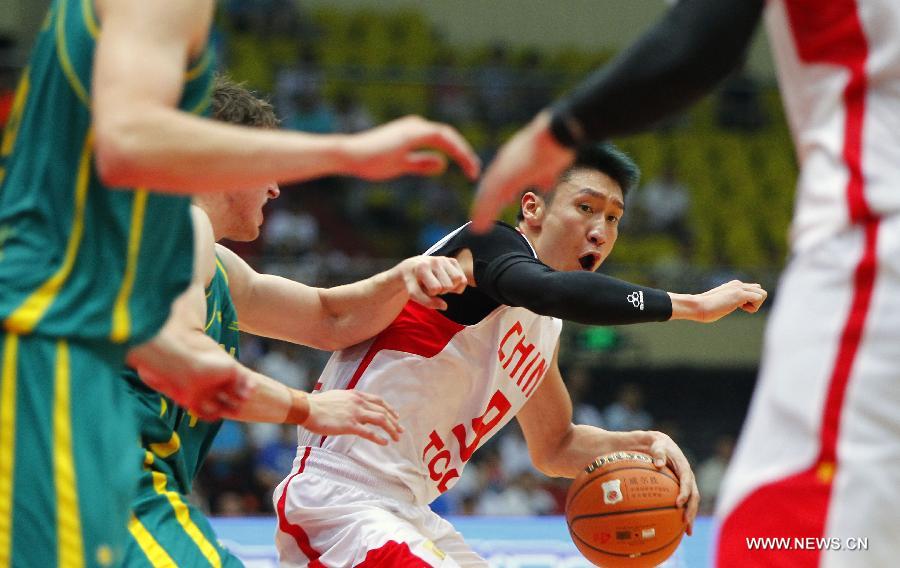 China's Sun Yue is defended by Australia's players during the 2013 Sino-Australian Men's International Basketball Challenge in Tianjin, north China, June 12, 2013. (Xinhua/Ding Xu)