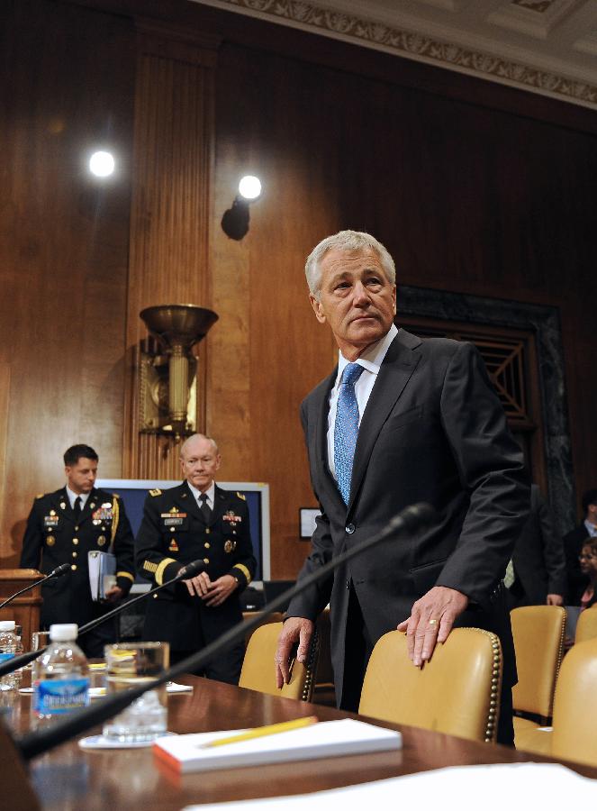 Chuck Hagel (R), U.S. Secretary of Defense and Martin Dempsey (C), Chairman of Joint Chiefs of Staff, arrive to testify before the U.S. Senate Budget Committee about U.S. President Barrack Obama's proposed budget request for fiscal year 2014 for defense, on Capitol Hill in Washington D.C., capital of the United States, June 12, 2013. (Xinhua/Zhang Jun) 