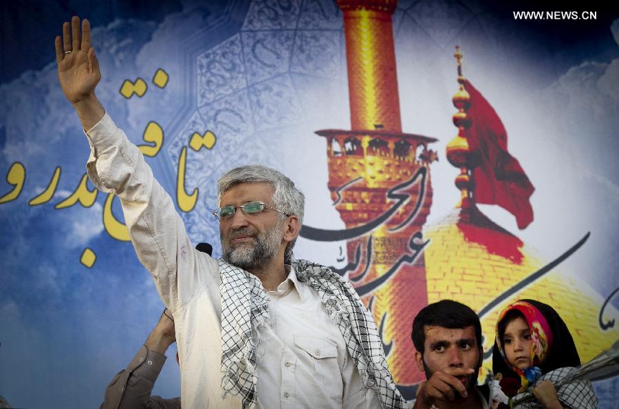 Iran's chief nuclear negotiator and presidential candidate Saeed Jalili (L) waves to supporters in his campaign rally in downtown Tehran, Iran, on June 12, 2013. Iran's 11th presidential election is scheduled for June 14. (Xinhua/Ahmad Halabisaz)