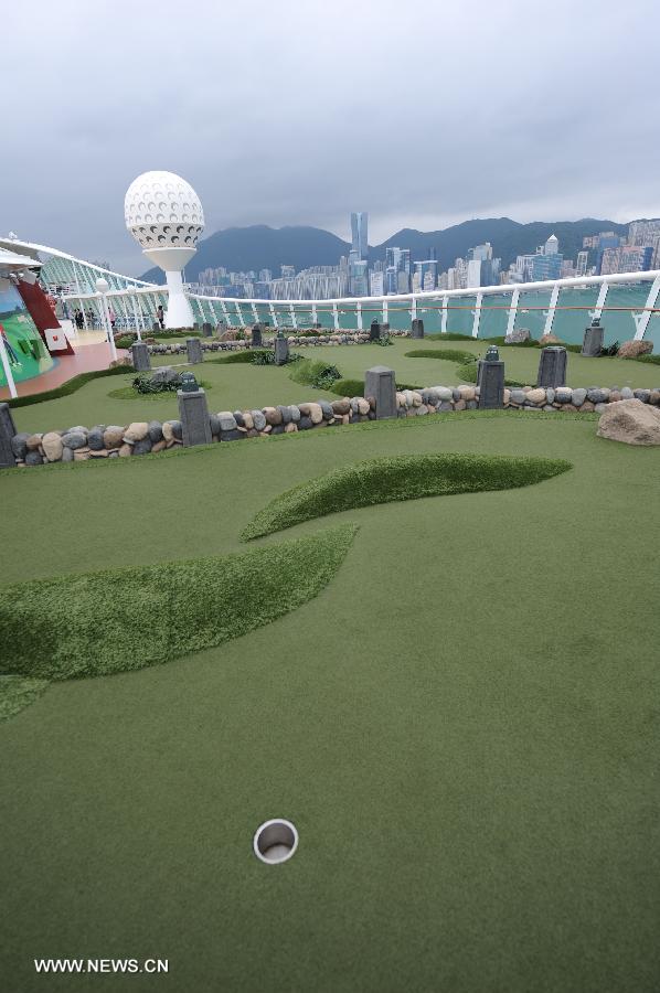 A golf course is seen on cruise liner Mariner of the Seas at the Kai Tak Cruise Terminal in Hong Kong, south China, June 13, 2013. The new cruise terminal, built at the end of the runway of the former Kai Tak Airport, received its first liner, Mariner of the Seas on June 12, which has a capacity of 3,807 people. (Xinhua/Lui Siu Wai)