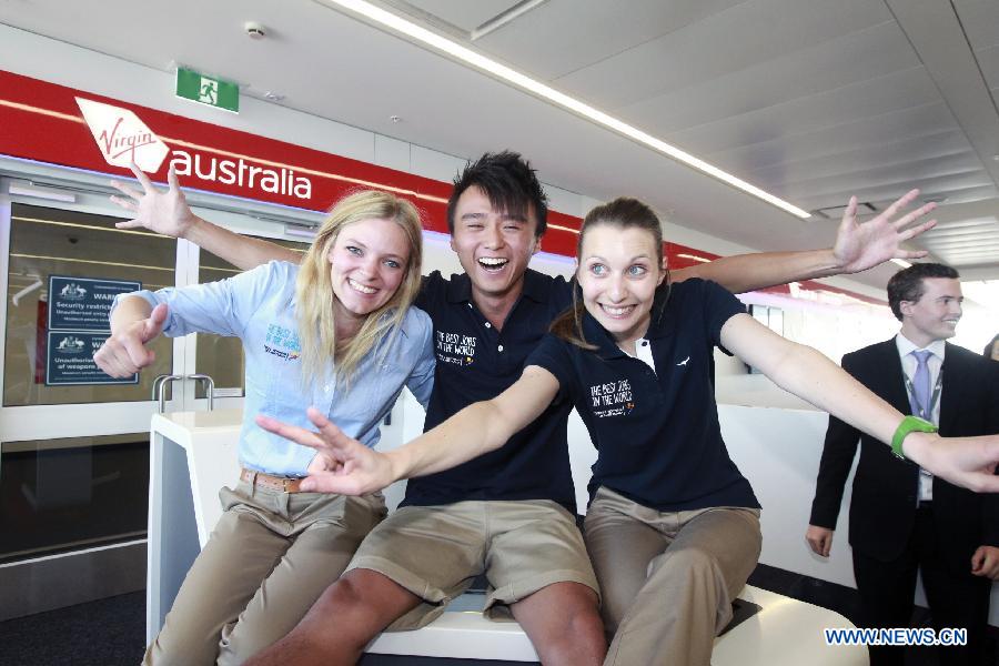 Finalists Chris Leung (C) from China's Hong kong, Jo Muskus (L) from Britain and Elisa Detriz from France pose for photos at the airport in Sydney, Australia, June 13, 2013. A total of 18 finalists arrived in Sydney Thursday, competing for the Best Jobs in the World including the Chief Funster in New South Wales, Lifestyle Photographer in Melbourne, Outback Adventurer in Northern Territory, Park Ranger in Queensland, Taste Master in Western Australia, and Wildlife Caretaker in South Australia. (Xinhua/Jin Linpeng) 
