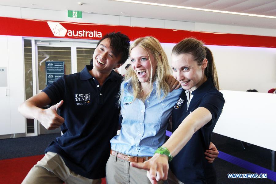 Finalists Chris Leung (L) from China's Hong kong, Jo Muskus (C) from Britain and Elisa Detriz from France pose for photos at the airport in Sydney, Australia, June 13, 2013. A total of 18 finalists arrived in Sydney Thursday, competing for the Best Jobs in the World including the Chief Funster in New South Wales, Lifestyle Photographer in Melbourne, Outback Adventurer in Northern Territory, Park Ranger in Queensland, Taste Master in Western Australia, and Wildlife Caretaker in South Australia. (Xinhua/Jin Linpeng) 