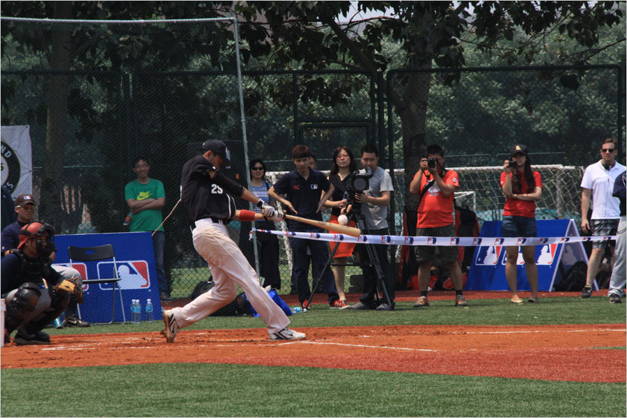 A player from the MLB College All-Star Team hits a home run during a home run derby competition on June 12, 2013, at Tsinghua University as part of the MLB University Cup event.(CRIENGLISH.com/Stuart Wiggin)