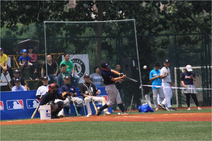 A player from the MLB Development Center (AAA) Team hits a home run during a home run derby competition on June 12, 2013, at Tsinghua University as part of the MLB University Cup event.(CRIENGLISH.com/Stuart Wiggin) 