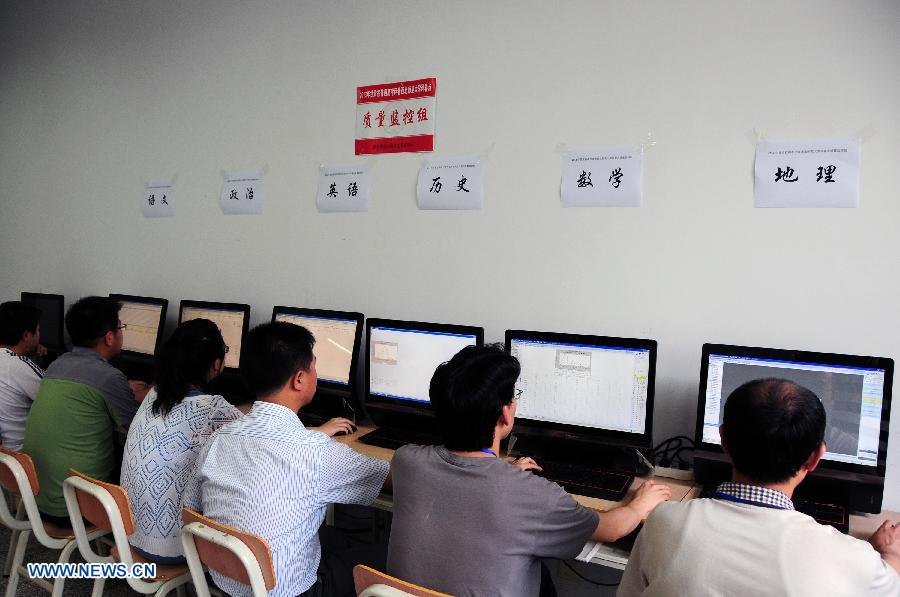 College entrance exam paper marking review staff work at a paper marking room in the Northwest Normal University in Lanzhou, capital of northwest China's Gansu Province, June 13, 2013. In total 2,150 paper marking staff members need to mark the exam papers of 283,424 participants of 2013 college entrance exam in Gansu from June 10 to June 22. (Xinhua/Fan Peikun)