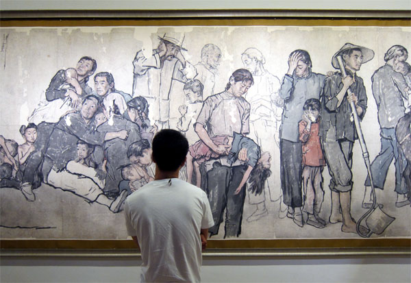 A man contemplates Jiang Zhaohe's painting "Wandering Refugees" (1943) at the National Art Museum of China. [Photo: CRIENGLISH.com/William Wang] 