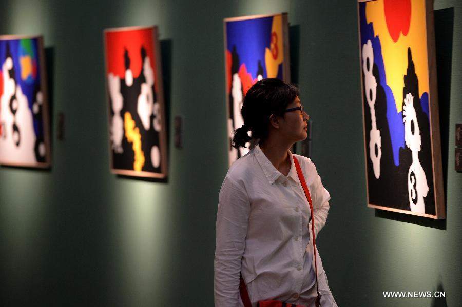 A visitor views artworks at an exhibition showcasing creations by Spanish art master Jose de Guimaraes at the Shaanxi Province Art Museum in Xi'an, northwest China's Shaanxi Province, June 14, 2013. The exhibition kicked off here on June 13 and displayed some 70 creations. (Xinhua/Li Yibo)