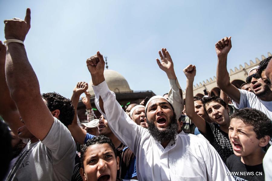 Egyptian protesters shout slogans during a protest against the Syrian president Bashar Al-Assad and supporting the Syrian uprising in the historical mosque of Amr ibn Al-As in old Cairo, Egypt, June 14, 2013. (Xinhua/Amru Salahuddien)