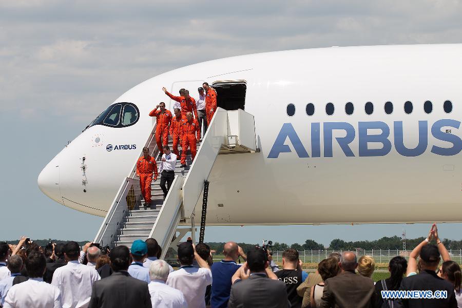 Crew members of Airbus's A350 XWB (eXtra Wide Body) plane walk out of the cabin after it landed at the Toulouse-Blagnac airport, southwestern France, on June 14, 2013. After its first four-hour test flight, the A350 XWB plane landed safely in southern France on Friday. (Xinhua/Chen Cheng)
