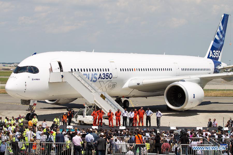 Crew members of Airbus's A350 XWB (eXtra Wide Body) plane attend a press conference after it landed at the Toulouse-Blagnac airport, southwestern France, on June 14, 2013. After its first four-hour test flight, the A350 XWB plane landed safely in southern France on Friday. (Xinhua/Chen Cheng)