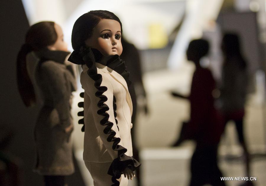 A dressed-up doll is seen at the Viktor & Rolf Dolls exhibit, as part of the 2013 Luminato Festival, at Royal Ontario Museum in Toronto, Canada, June 14, 2013. Every aspect of each doll's look was scaled down to create exact replicas of the original creation by designers Viktor Horsting and Rolf Snoeren. (Xinhua/Zou Zheng)