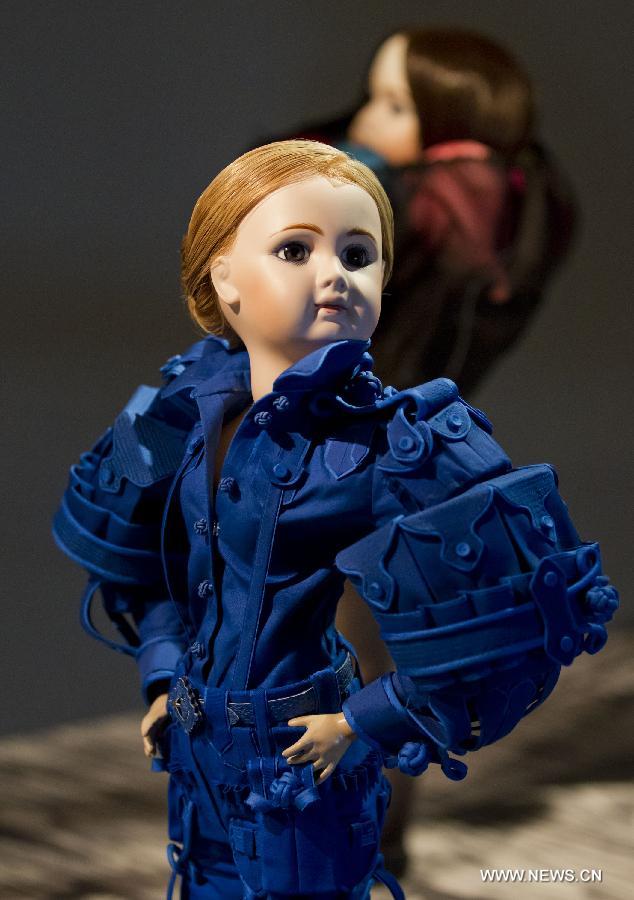 A dressed-up doll is seen at the Viktor & Rolf Dolls exhibit, as part of the 2013 Luminato Festival, at Royal Ontario Museum in Toronto, Canada, June 14, 2013. Every aspect of each doll's look was scaled down to create exact replicas of the original creation by designers Viktor Horsting and Rolf Snoeren. (Xinhua/Zou Zheng)