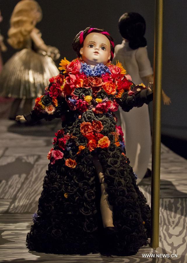 Dressed-up dolls are seen at the Viktor & Rolf Dolls exhibit, as part of the 2013 Luminato Festival, at Royal Ontario Museum in Toronto, Canada, June 14, 2013. Every aspect of each doll's look was scaled down to create exact replicas of the original creation by designers Viktor Horsting and Rolf Snoeren. (Xinhua/Zou Zheng)