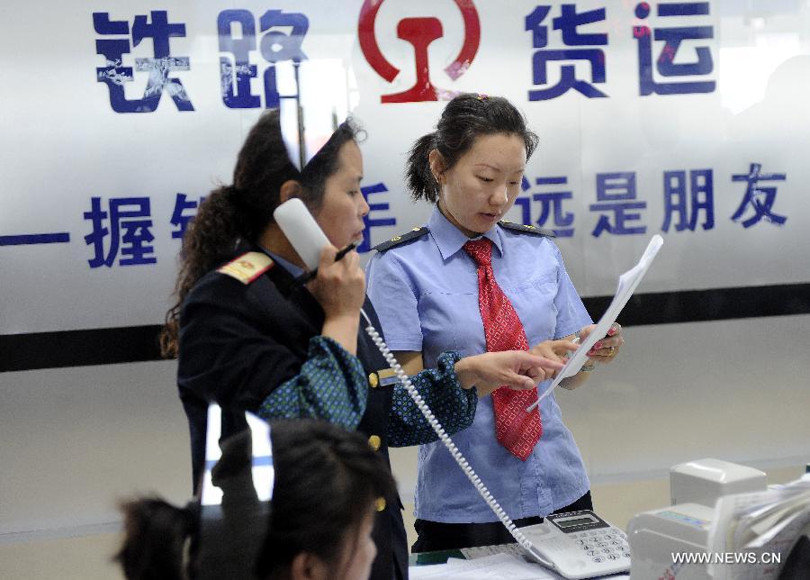 Railway employees work behind a counter offering freight transport service at the Lhasa West Railway Station in Lhasa, capital of southwest China's Tibet Autonomous Region, June 15, 2013. The China Railway Corporation, a commercial arm separated from the nation's ex-railways ministry, said Saturday that it will push its freight transport services to cover a bigger market. A company spokesman said it will work toward that goal through a slew of reforms focused on efficiency and better services, in efforts to transform the company's freight transport into a modern logistics business. (Xinhua/Chogo) 