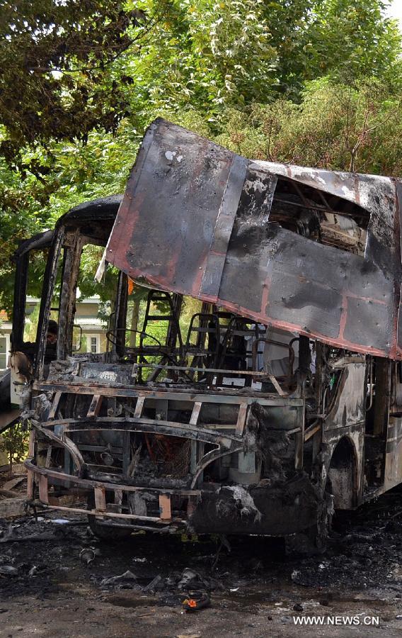 Wreckage of a destroyed university bus is seen at the blast site in southwest Pakistan's Quetta, June 15, 2013. At least 11 people were killed and 22 others injured as a blast hit a university bus in Pakistan's southwest city of Quetta on Saturday afternoon, police said. (Xinhua/Asad)