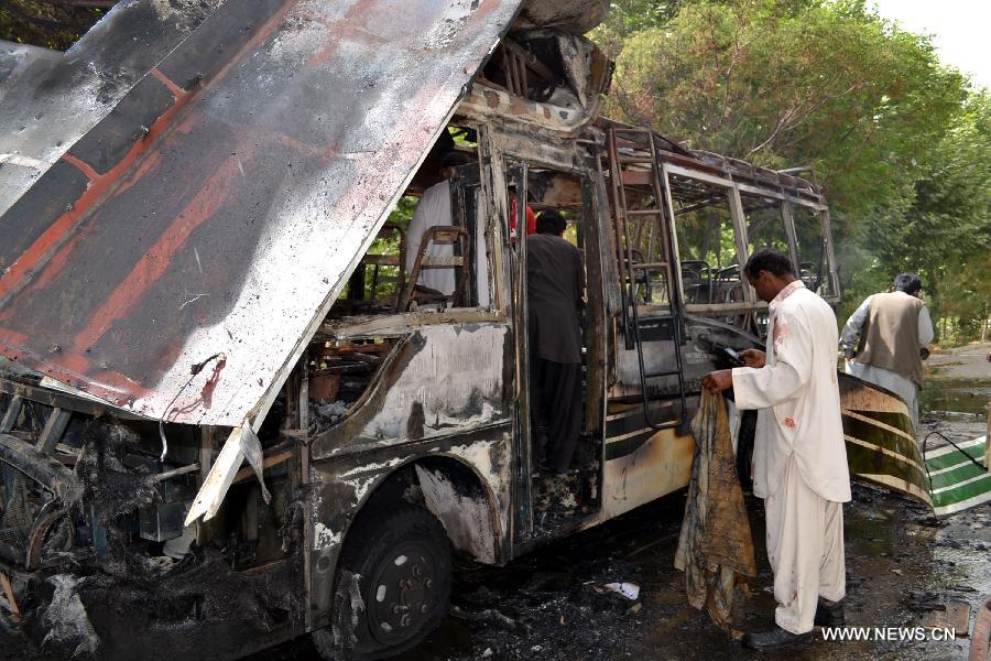 Rescuers inspect the wreckage of a destroyed university bus at the blast site in southwest Pakistan's Quetta, June 15, 2013. At least 11 people were killed and 22 others injured as a blast hit a university bus in Pakistan's southwest city of Quetta on Saturday afternoon, police said. (Xinhua/Asad) 