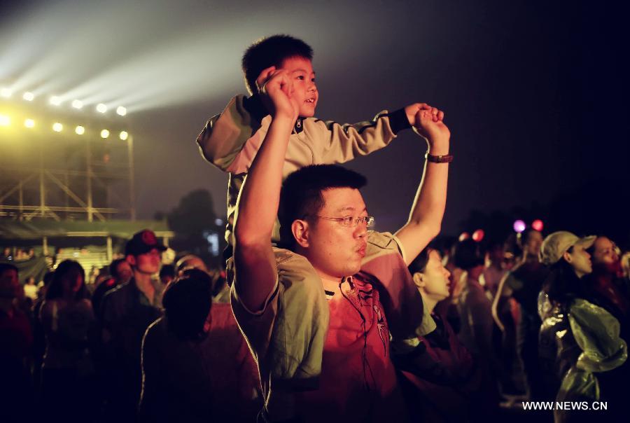 A child sits on his father's shoulder at a musical festival in Changsha, capital of central China's Hunan Province, June 10, 2013. The third Sunday in June marks the Father's Day, which falls on June 16 this year. (Xinhua/Li Ga)  