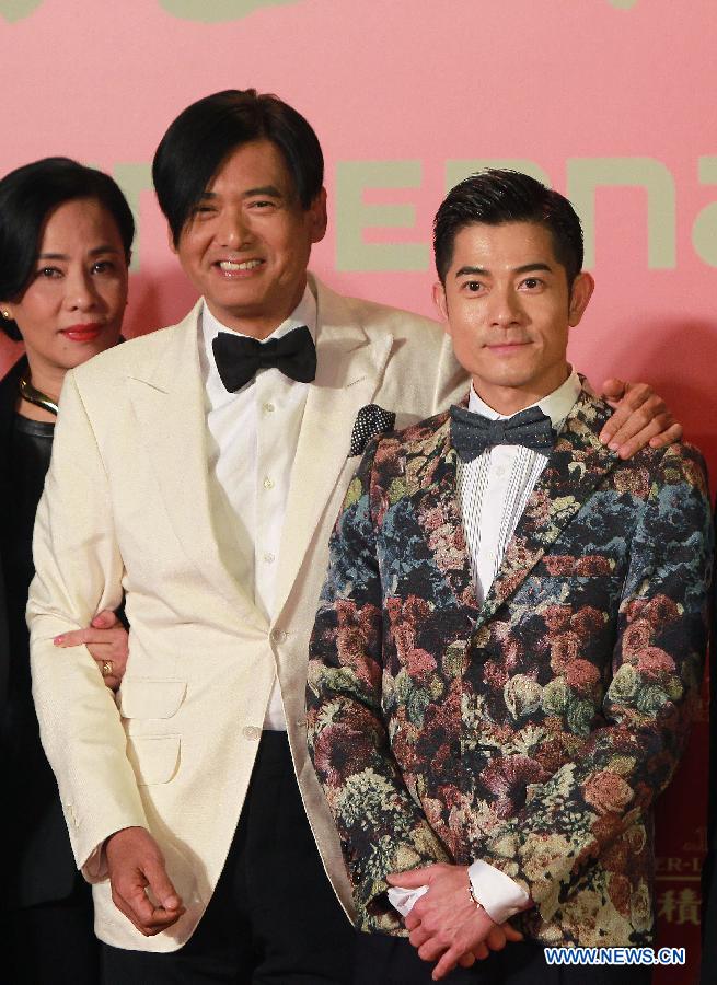 Movie stars Chow Yun-fat (C) and Aaron Kwok (R) pose on the red carpet for the opening ceremony of the 16th Shanghai International Film Festival in Shanghai, east China, June 15, 2013. (Xinhua/Ding Ding)