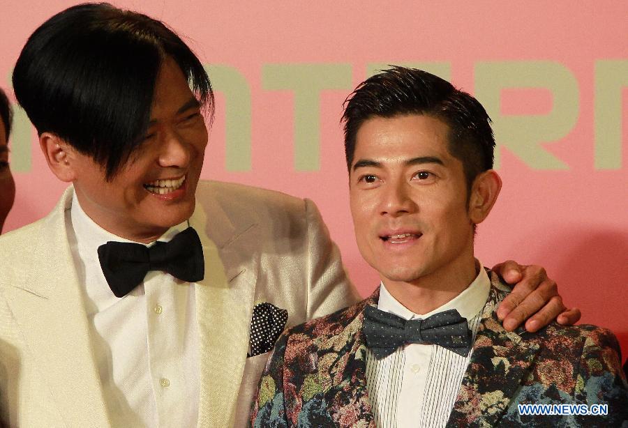 Movie stars Chow Yun-fat (L) and Aaron Kwok pose on the red carpet for the opening ceremony of the 16th Shanghai International Film Festival in Shanghai, east China, June 15, 2013. (Xinhua/Ding Ding)