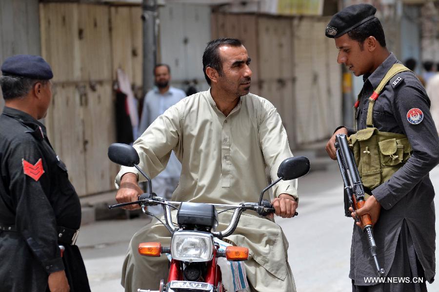 A policeman checks a motorbike rider during strike over terror attacks in southwest Pakistan's Quetta, on June 16, 2013. A day of mourning was observed across Pakistan's southwestern Balochistan province on Sunday over Saturday's bombings targeting the Women University bus and the Bolan Medical Complex which has claimed 20 precious lives. (Xinhua/Mohammad)  