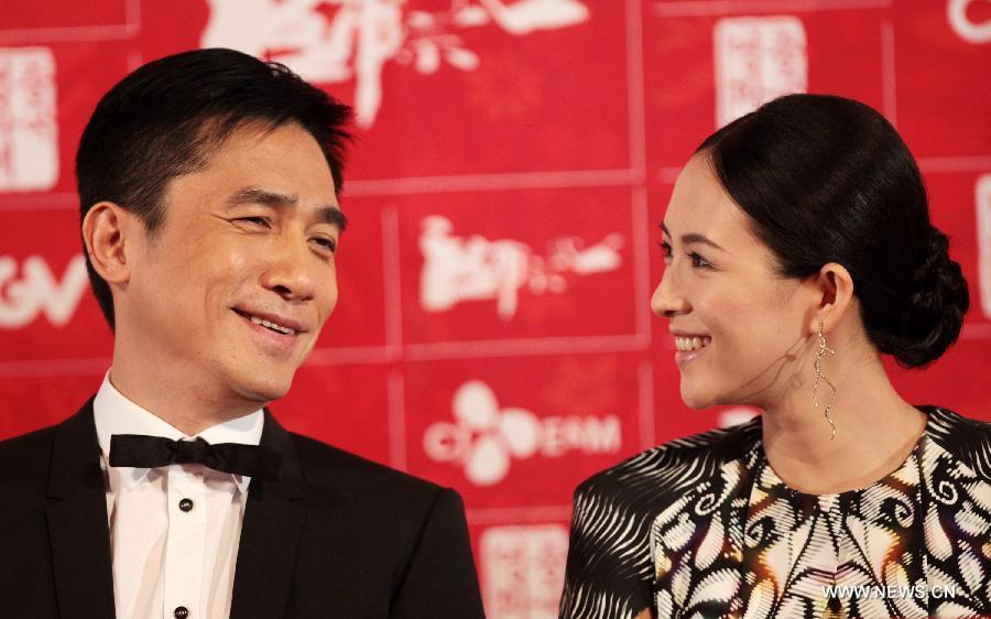 Hong Kong actor Tony Leung (L) and Chinese actress Zhang Ziyi react during the press conference for 2013 Chinese Film Festival in Seoul, South Korea, June 16, 2013. The 5th Chinese Film Festival opened in Seoul on Sunday for a 5-day celebration of Chinese film to boost bilateral movie and culture cooperation. Their movie "The Grandmaster" has been selected as the opening film of 2013 Chinese Film Festival. (Xinhua/Park Jin-hee) 