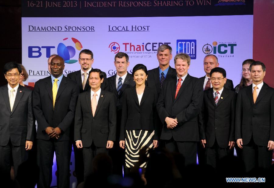 Thai Prime Minister Yingluck Shinawatra (C) poses for group photos with delegates during the opening ceremony of the 25th annual Forum of Incident Response and Security Teams (FIRST) conference in Bangkok, capital of Thailand, June 17, 2013. Under the theme of "Incident Response: Sharing to win", the five-day conference brings together leading experts from all over the world to share ideas on international security. (Xinhua/Gao Jianjun)