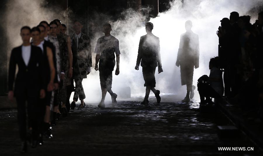Models display creations during SS14 Alexander McQueen Menswear show at the Coal Drops, King's Cross in London, Britain on June 17, 2013. (Xinhua/Wang Lili) 
