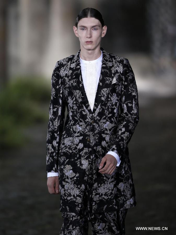 A model displays a creation during SS14 Alexander McQueen Menswear show at the Coal Drops, King's Cross in London, Britain on June 17, 2013. (Xinhua/Wang Lili) 