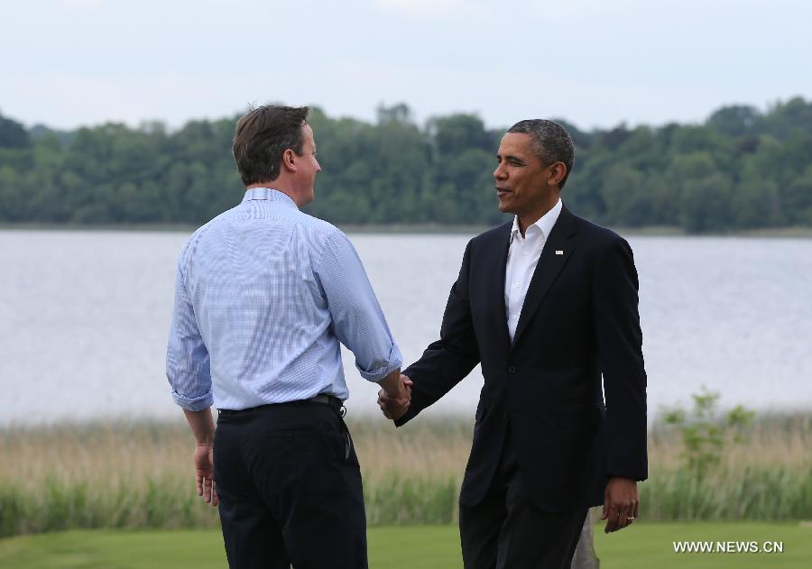 Britain's Prime Minister David Cameron (L) shakes hands with U.S. President Barack Obama during the official welcome as world leaders arrive for the openning ceremony of the G8 Summit at the Lough Erne resort near Enniskillen in Northern Ireland June 17, 2013. The focus of the Group of Eight (G8) industrialized nations' annual summit were expected to be on Syria and economic issues. (Xinhua/Yin Gang) 