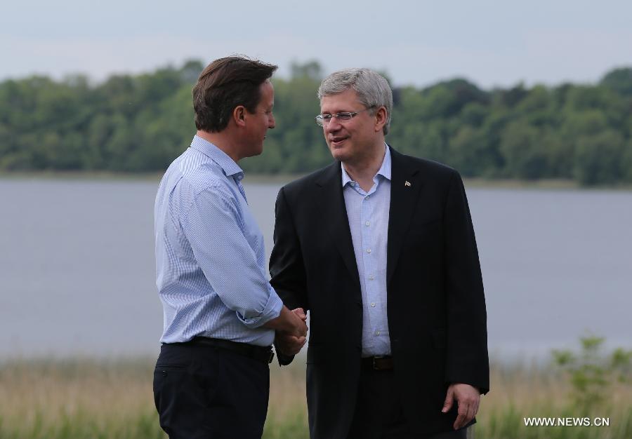 Britain's Prime Minister David Cameron (L) shakes hands with Canadian Prime Minister Stephen Harper during the official welcome as world leaders arrive for the openning ceremony of the G8 Summit at the Lough Erne resort near Enniskillen in Northern Ireland June 17, 2013. The focus of the Group of Eight (G8) industrialized nations' annual summit were expected to be on Syria and economic issues. (Xinhua/Yin Gang) 