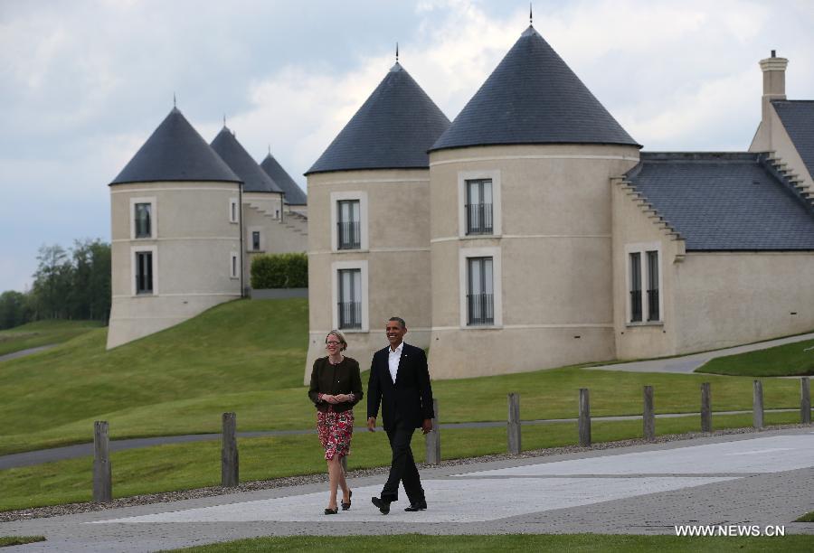 U.S. President Barack Obama walks towards the meetingplace during the official welcome as world leaders arrive for the openning ceremony of the G8 Summit at the Lough Erne resort near Enniskillen in Northern Ireland June 17, 2013. The focus of the Group of Eight (G8) industrialized nations' annual summit were expected to be on Syria and economic issues. (Xinhua/Yin Gang) 