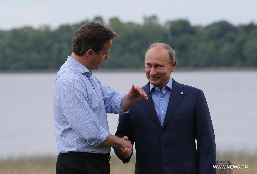 Britain's Prime Minister David Cameron (L) shakes hands with Russia's President Vladimir Putin during the official welcome as world leaders arrive for the openning ceremony of the G8 Summit at the Lough Erne resort near Enniskillen in Northern Ireland June 17, 2013. The focus of the Group of Eight (G8) industrialized nations' annual summit were expected to be on Syria and economic issues. (Xinhua/Yin Gang) 