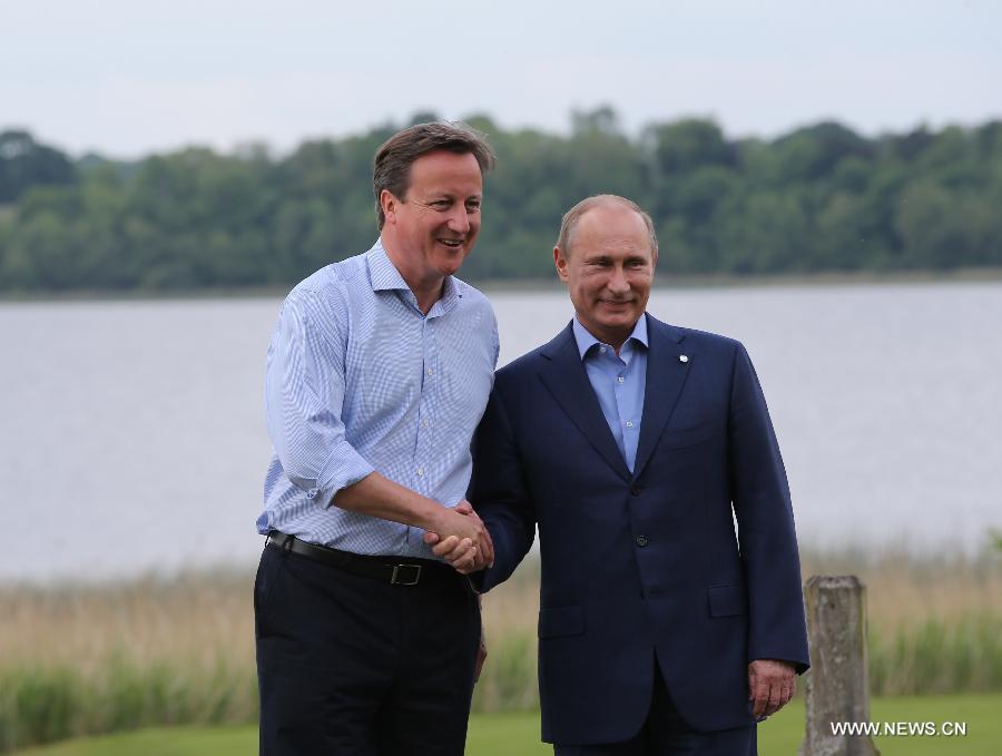Britain's Prime Minister David Cameron (L) and Russia's President Vladimir Putin pose for photo during the official welcome as world leaders arrive for the openning ceremony of the G8 Summit at the Lough Erne resort near Enniskillen in Northern Ireland June 17, 2013. The focus of the Group of Eight (G8) industrialized nations' annual summit were expected to be on Syria and economic issues. (Xinhua/Yin Gang) 