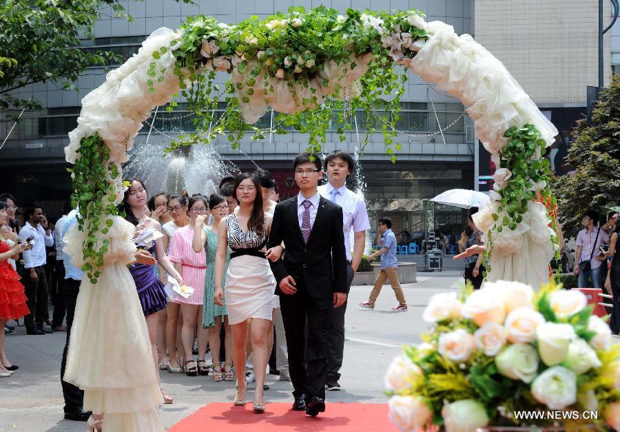 Graduates of the School of Medicine of the Southeast University (SEU) walk on the red carpet during their graduation ceremony in Nanjing, capital of east China's Jiangsu Province, June 17, 2013. (Xinhua/Sun Can)