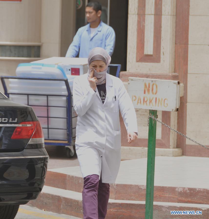 A health worker walks out of a hospital in the eastern Saudi Arabia city of Khobar, on June 17, 2013. Four more people have died in Saudi Arabia from SARS-like coronavirus, Saudi Arabia's Health Ministry said, bringing to 32 the number of death from the desease in the kingdom, 49 the number of infection. (Xinhua/Wang Bo) 