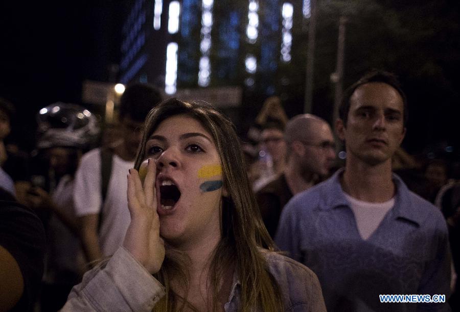 A young student shouts slogans during a protest against the millions of dollars Brazilian government spending for the FIFA Confederations Cup Brazil 2013 and World Cup Brazil 2014, at the Obelisco of Belo Horizonte, Minas Gerais state, Brazil, on June 17, 2013. The FIFA Confederations Cup Brazil 2013 is held from June 15 to June 30. (Xinhua/David de la Paz)