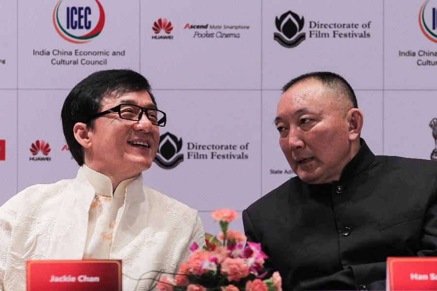 Actor Jackie Chan (L) talks with Chairman of China Film Group Corporation Han Sanping at the news conference of the Chinese film festival in New Delhi, India, on June. 18, 2013. The 5-day festival opened on Tuesday to boost bilateral movie and culture cooperation between China and India. (Xinhua/Zheng Huansong) 