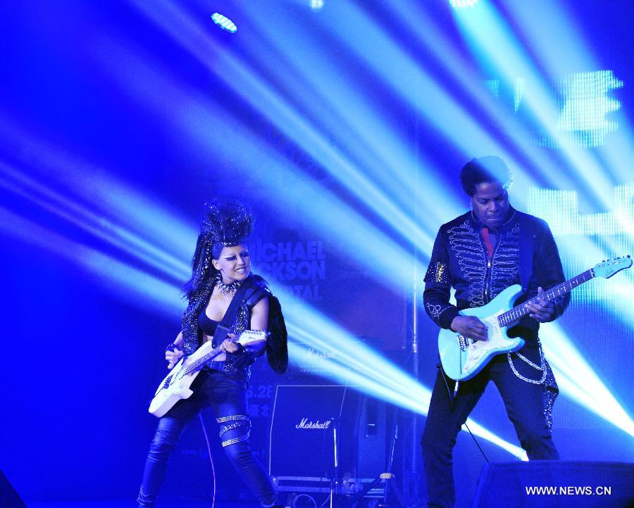 Guitar players perform during a press conference for the Michael Jackson The Immortal World Tour in Taipei, southeast China's Taiwan, June 18, 2013. The world tour concert will be held in the Taipei Arena from June 28 to June 30, and will be held in Beijing, Shanghai and Hong Kong in August. (Xinhua/Wu Ching-teng) 