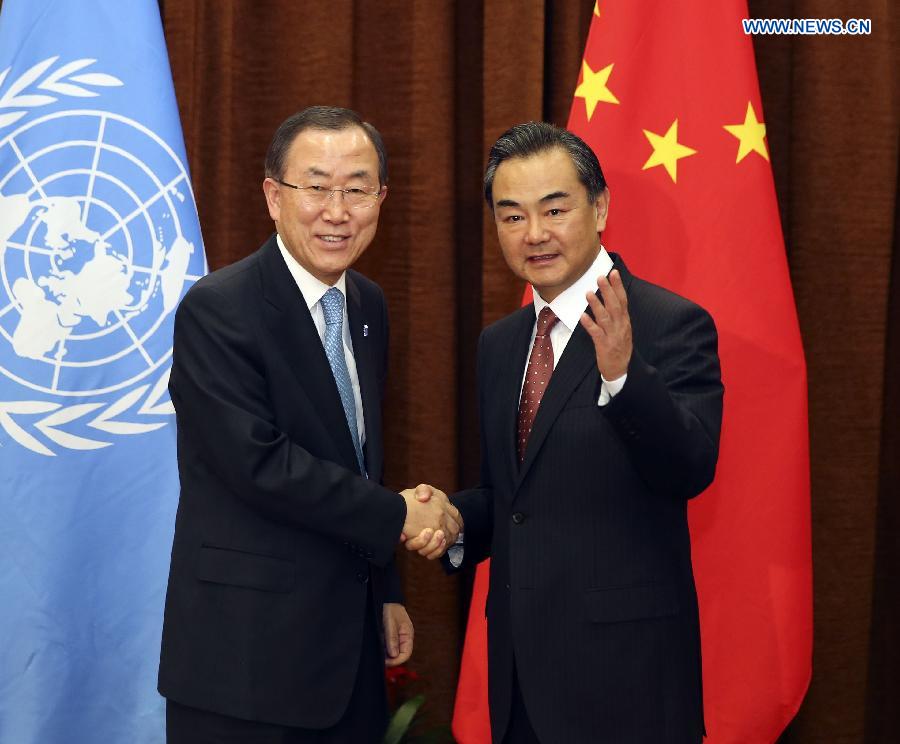 Chinese Foreign Minister Wang Yi (R) shakes hands with UN Secretary-General Ban Ki-moon in Beijing, capital of China, June 19, 2013.(Xinhua/Ding Lin) 