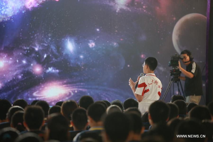 Students wait for the beginning of the space lecture at the ground classroom set at the High School Affiliated to Renmin University of China, in Beijing, capital of China, June 20, 2013. A special lecture will begin at about 10:00 a.m. Beijing time Thursday morning, given by a teacher aboard China's space module Tiangong-1 to students on Earth. (Xinhua/Wang Yongzhuo)