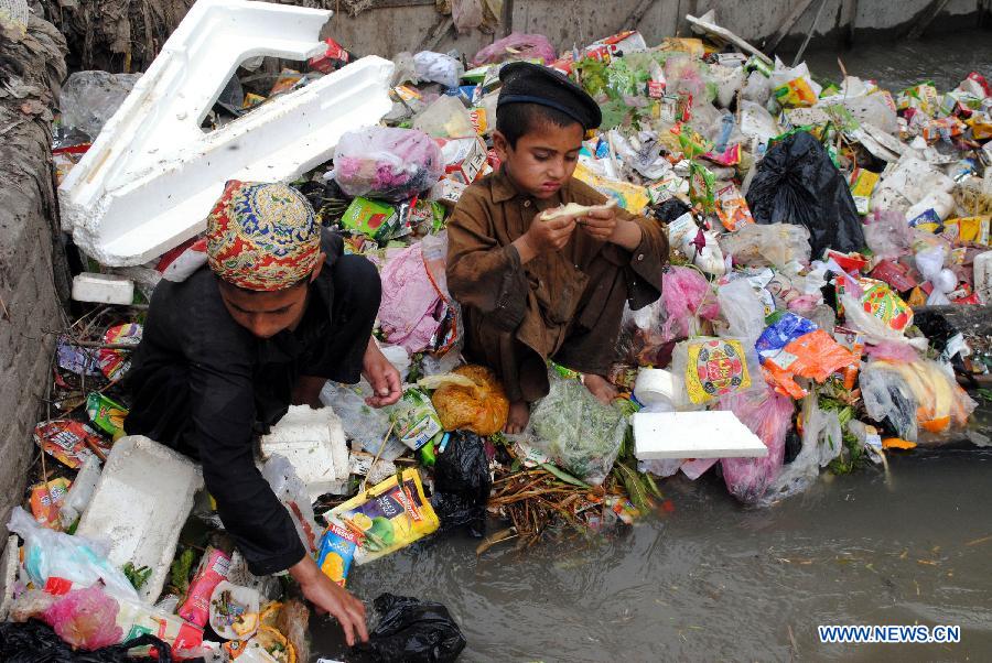 Afghan refugees search for reusable materials from a garbage dump on the eve of World Refugee Day in northwest Pakistan's Peshawar, June 19, 2013. There are 1.65 million registered Afghans currently living in Pakistan. Since 2002, UNHCR's voluntary repatriation program has assisted more than 3.8 million Afghan refugees to return home. (Xinhua/Umar Qayyum)