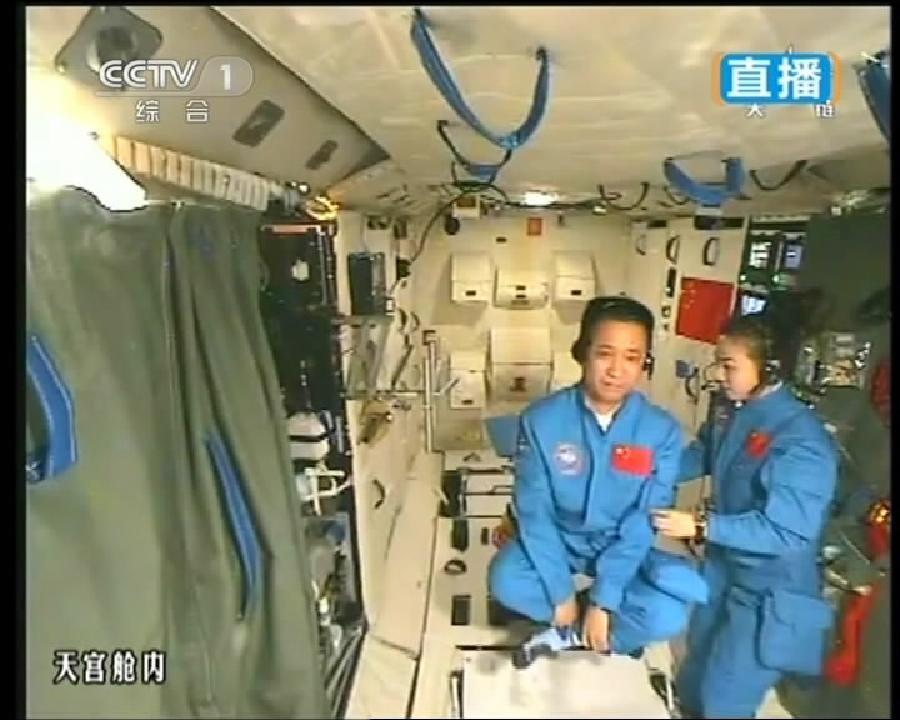 This TV grab taken on June 20, 2013 shows female astronaut Wang Yaping (R), one of the three crew members of Shenzhou-10 spacecraft, giving a lecture to students on Earth aboard China's space module Tiangong-1. A special lecture began Thursday morning, given by Wang Yaping aboard China's space module Tiangong-1 to students on Earth. (Xinhua)