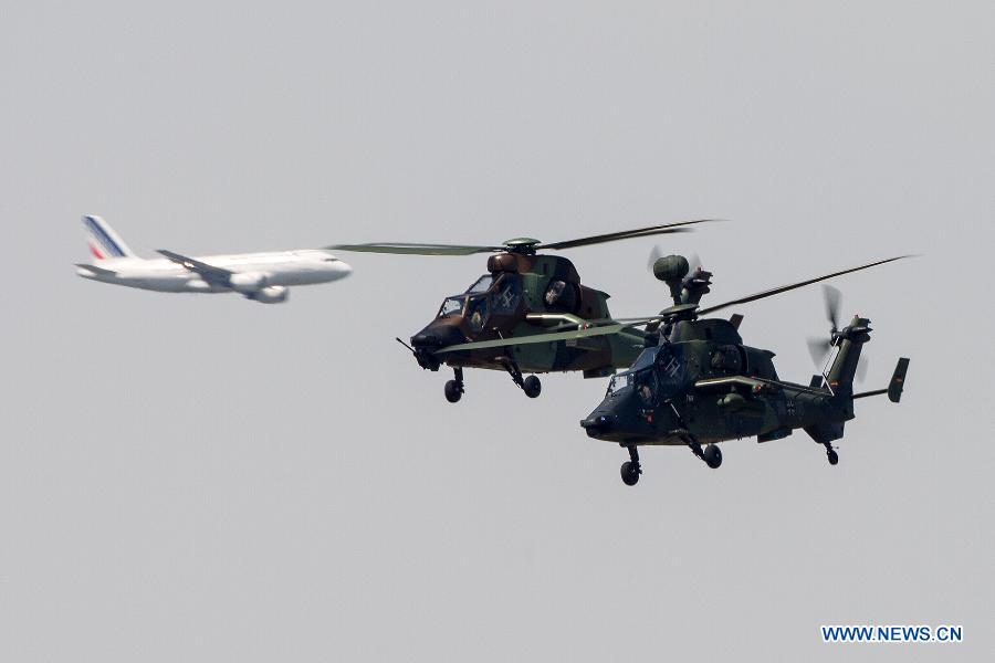 Tiger helicopters participate in a flying display during the 50th International Paris Air Show at the Le Bourget airport in Paris, France, June 17, 2013. The Paris Air Show runs from June 17 to 23. (Xinhua/Chen Cheng)