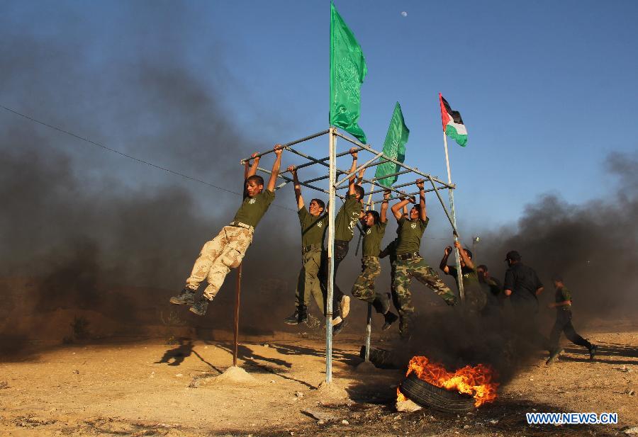 Palestinian boys take part in a military exercises during a military graduation ceremony organized by Hamas movement in the southern Gaza Strip city of Rafah on June 19, 2013. (Xinhua/Khaled Omar) 