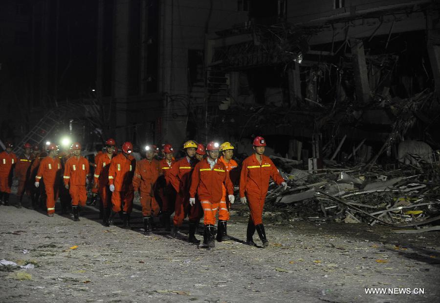 Rescuers of local fire brigade withdraw from the locale of a restaurant blast after finishing their work in Shuozhou City of north China's Shanxi Province, in the early morning of June 20, 2013. Blasts ripped through a restaurant in Shuozhou Wednesday night, killing three people and injuring 149 others. (Xinhua/Yan Yan)